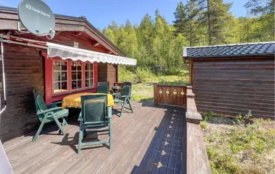 a deck with a table and chairs on a cabin at 3 Bedroom Gorgeous Home In Nordberg in Nordberg