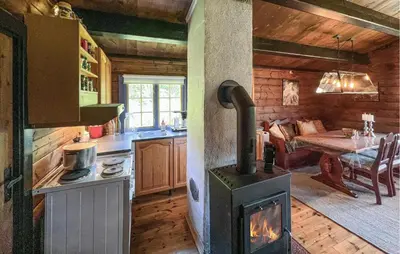 a kitchen with a wood stove in a room at 3 Bedroom Gorgeous Home In Nordberg in Nordberg