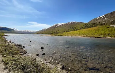 a river with rocks in the water with mountains at 3 Bedroom Gorgeous Home In Nordberg in Nordberg