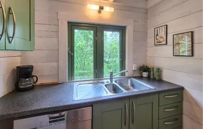 a kitchen with a sink and a window at Nice Home In Aksdal With House Sea View in Aksdal