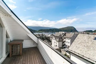 a balcony with a view of a city at Large apartment with 5 bedrooms, 2 bathrooms and roof terrace in Ålesund