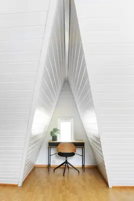 a desk in a room with a large white wall at City apartment with 4 bedrooms & private terrace in Ålesund