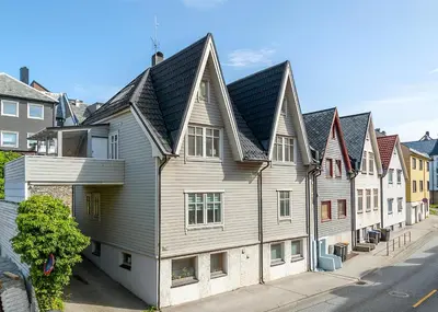 a row of houses on a city street at City apartment with 4 bedrooms & private terrace in Ålesund