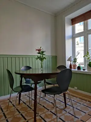 a dining room with a wooden table and chairs at You cottage in the city in Bergen