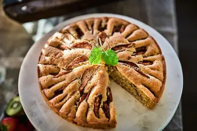 a pie with a green leaf on top of it at Stangeland Gard in Austevoll
