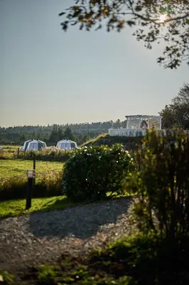 a view of a field with tents in the distance at Stangeland Gard in Austevoll
