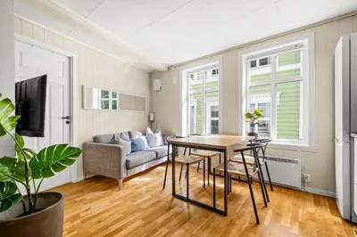 a living room with a table and a couch at Bergen Charm - Right in the City Center! in Bergen