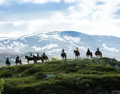 a group of people riding horses on a hill at 4-Bedroom Ski-In Family Cabin at Geilolia hyttetun in Hol