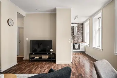 a living room with a television and a couch at BB Apartments I 300m to Bryggen & Train Station in Bergen