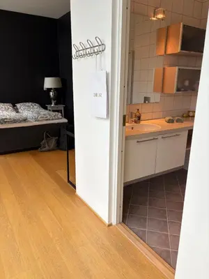a room with a kitchen and a bedroom with a bed at Exclusive seafront villa in Ålesund