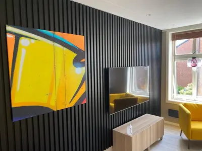 a living room with a large painting on the wall at 4 bedroom apartment in Ålesund City in Ålesund
