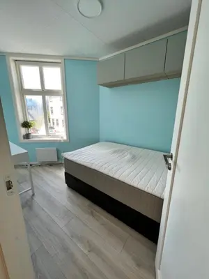 a bedroom with a bed and a window at 4 bedroom apartment in Ålesund City in Ålesund