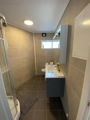 a bathroom with a sink and a shower at 4 bedroom apartment in Ålesund City in Ålesund