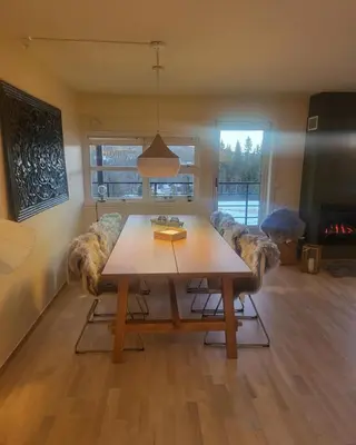a living room with a wooden table and chairs at Synnseter, Synnfjellet, Fjellstuguvegen 38, 2880 Nord Torpa in Lii