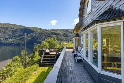 a porch of a house with a view of the water at Bluewater Cottage - Blåvannshytta in Bergen