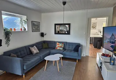a living room with a blue couch and a table at Bluewater Cottage - Blåvannshytta in Bergen
