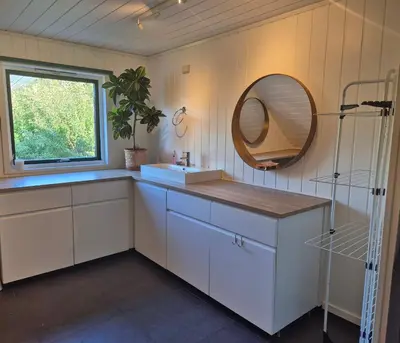 a bathroom with a sink and a mirror at Bluewater Cottage - Blåvannshytta in Bergen