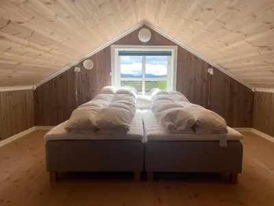 a bed in a room with a window at Modern Mountain Escape in Beitostøl