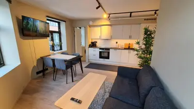 a living room with a couch and a table at Central and Spacious Apartment for 6 in Trondheim
