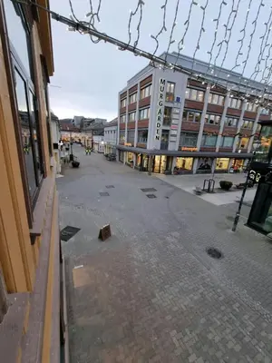 an empty street in a city with a building at Central and Spacious Apartment for 6 in Trondheim