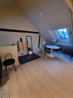 a room with a table and chairs in a attic at Central Studio for 2 in Trondheim