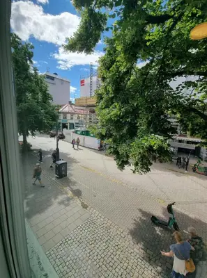 a group of children playing on a street in a city at Central Apartment for 4 in Trondheim