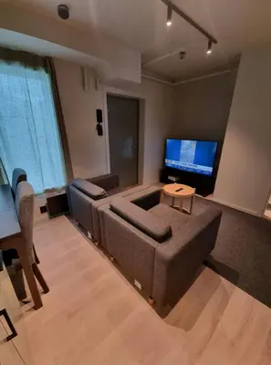 a living room with a couch and a flat screen tv at Central Apartment for 4 in Trondheim