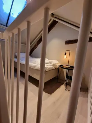 a bedroom with a bunk bed and a table at Central and Spacious Apartment for 8 in Trondheim