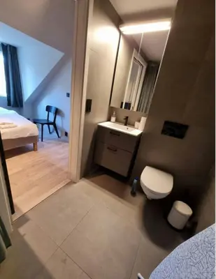 a small bathroom with a sink and a toilet at Central Apartment for 2 in Trondheim