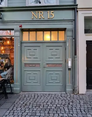 a green garage door with the number on it at Central Apartment for 2 in Trondheim