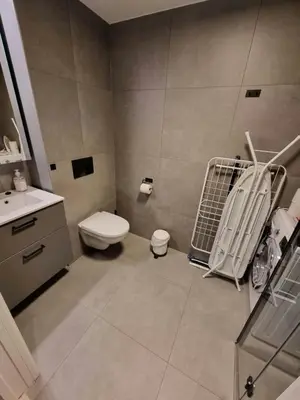 a bathroom with a toilet and a sink at Central Apartment for 2 in Trondheim