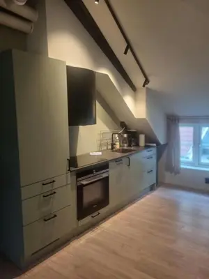 a kitchen with stainless steel appliances and a window at Central Apartment for 5 in Trondheim
