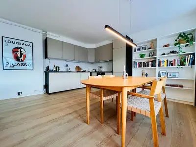 a kitchen and dining room with a wooden table and chairs at Central apartment in Trondheim in Trondheim