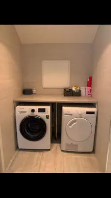 a laundry room with a washing machine and a washer at Duplex near airport in Bergen