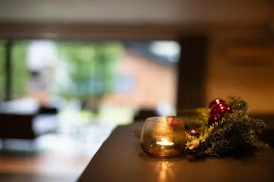 a christmas ornament and a candle on a table at Elvehagen Hotell in Sande
