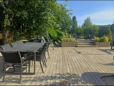 a black table and chairs on a wooden deck at Villa Varden 10 min from Bergen sentrum in Bergen