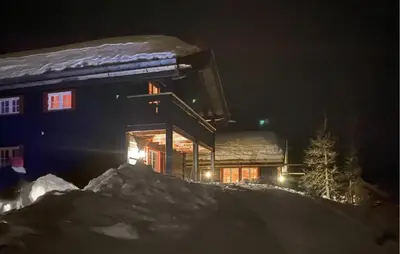 a building with lights on in the snow at night at Amazing Home In Eggedal With Sauna in Eggedal