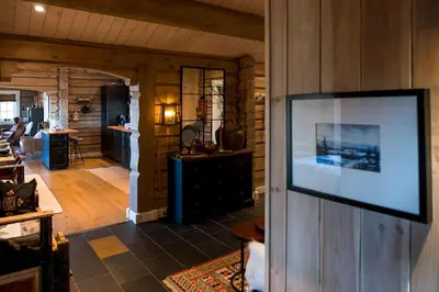 a flat screen tv hanging on a wall in a living room at Tømmerhytte Med Utsikt Over Jotunheimen in Gålå