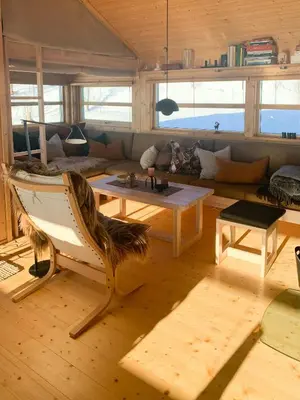 a living room with a couch and a table at Modern Cabin With Views Of Hallingskarvet in Torpo