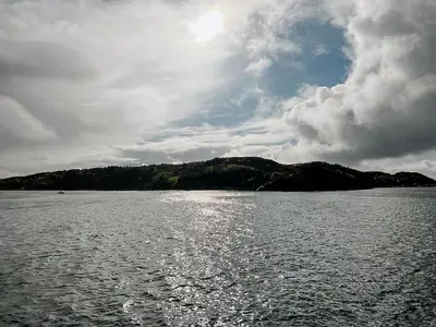 a view of a body of water with a cloudy sky at Architectural Gem On Rocks In Kvenvær in Kvenvær