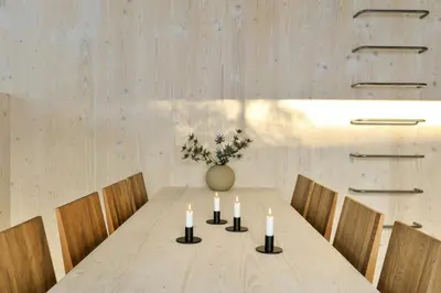 a dining room table with candles and a vase with flowers at Modern Family Cabin With Trysil Mountain Views in Trysil