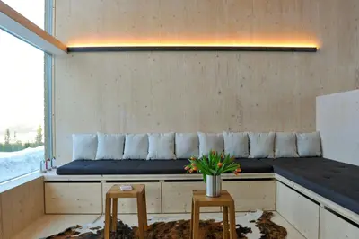 a bench in a room with two stools at Modern Family Cabin With Trysil Mountain Views in Trysil