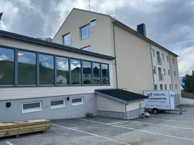 a large white building with a lot of windows at Åndalsnes House---Apartments in Åndalsnes