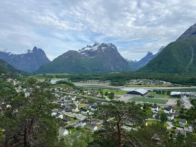 a town in a valley with mountains in the background at Åndalsnes House---Apartments in Åndalsnes