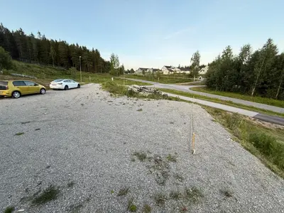 a parking lot with two cars on a road at Cozy house on Gryttingshaugen, near Vinstra in Sør-Fron