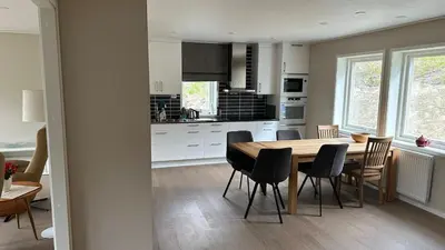 a kitchen and dining room with a table and chairs at Cozy house on Gryttingshaugen, near Vinstra in Sør-Fron