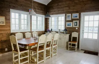 a dining room with a wooden table and chairs at Modern Family Cabin With Views Of Spåtind in Etnedal