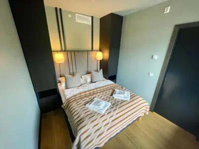 a small bedroom with a bed with two pillows at Gausta Sportell in Gaustablikk