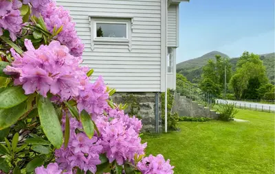 a house with pink flowers in front of it at Awesome Home In Åheim With Wifi in Åheim