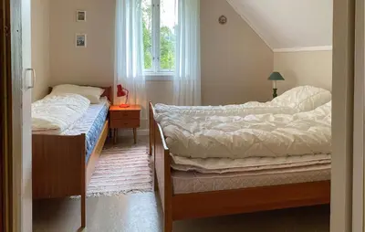 a bedroom with two beds and a window at Awesome Home In Åheim With Wifi in Åheim